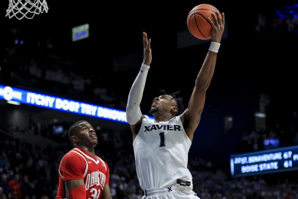 Xavier's Paul Scruggs (1) drives to the basket during the second half of an NCAA college basketball game against Ohio State, Thursday, Nov. 18, 2021, in Cincinnati. (AP Photo/Aaron Doster)