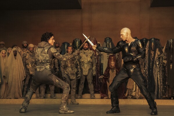 This image released by Warner Bros. Pictures shows Timothee Chalamet, foreground left, and Austin Butler in a scene from "Dune: Part Two." (Warner Bros. Pictures via AP)