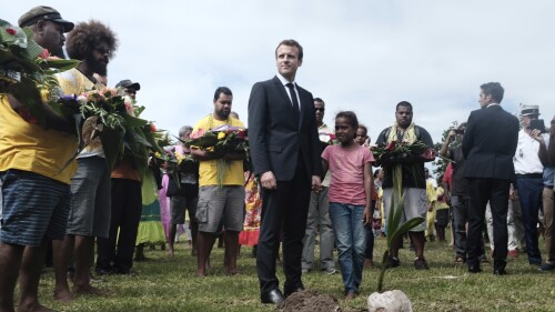 FILE - French President Emmanuel Macron pays tribute to the Kanak tribe of Hwadrilla, where the 19 Kanak militants are buried, on Ouvea Island, off New Caledonia, Saturday, May 5, 2018. The French president is heading to the South Pacific on Monday, July 24, 2023 to make France’s voice heard in a region shaping up as a prime geopolitical battleground for China and the United States. President Emmanuel Macron’s trip to Papua New Guinea, Vanuatu and New Caledonia comes as French forces take part in massive U.S.-Australian-led military exercises in the region. (AP Photo/Theo Rouby, file)