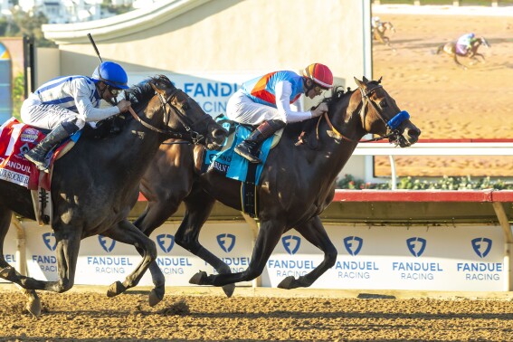 In this image provided by Benoit Photo, Arabian Knight, right, with Flavien Prat aboard, right, holds off Geaux Rocket Ride, left, with Mike Smith aboard, to win the Grade I $1,000,000 Pacific Classic horse race Saturday, Sept. 2, 2023, at Del Mar Thoroughbred Club in Del Mar, Calif. (Benoit Photo via AP)