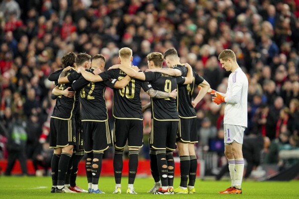 FILE - Sparta Prague players gather together on the pitch before the Europa League round of 16, second leg, soccer match between Liverpool and Sparta Prague at Anfield Stadium, Liverpool, England, on March 14, 2024. Sparta Prague said Lars Friis was signed by the Czech champion to become the team’s new coach and replace his fellow Dane Brian Priske who moves to Feyenoord in the Dutch league. (AP Photo/Jon Sup, File)