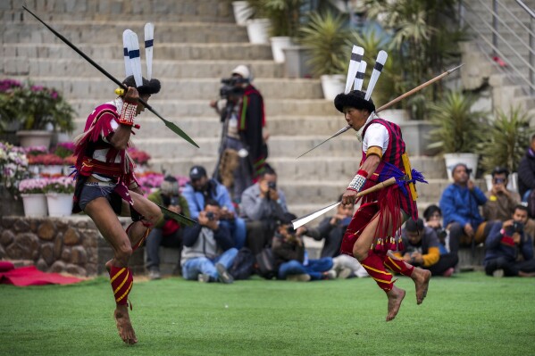 Indigenous Nagas perform a warrior dance dance during the Hornbill Festival in Kisama, on the outskirts of Kohima, capital of the northeastern Indian state of Nagaland, Tuesday, Dec. 10, 2024. (AP Photo/Anupam Nath)