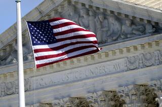 FILE - An American flag waves in front of the Supreme Court building, Nov. 2, 2020, on Capitol Hill in Washington. (AP Photo/Patrick Semansky, File)