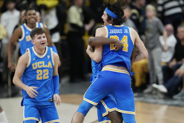 UCLA guard Jaime Jaquez Jr., front right, celebrates with guard David Singleton, back right, as guard Jack Seidler joins in after time ran out in the second half of an NCAA college basketball game against Colorado, Sunday, Feb. 26, 2023, in Denver. (AP Photo/David Zalubowski)