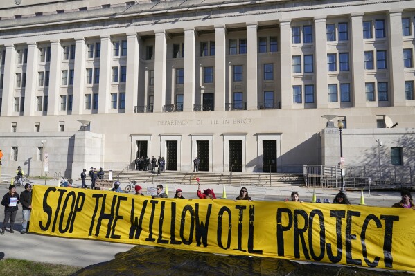 FILE - Demonstrators protest against the Biden administration's approval of the Willow oil-drilling project before a scheduled speech by Biden at the Department of the Interior in Washington, March 21, 2023. A federal judge on Thursday, Nov. 9 upheld the Biden administration's approval of the Willow oil-drilling project on Alaska's remote North Slope, a massive project that had drawn the ire of environmentalists who accused the president of backpedaling on his pledge to combat climate change. (AP Photo/Patrick Semansky, File)