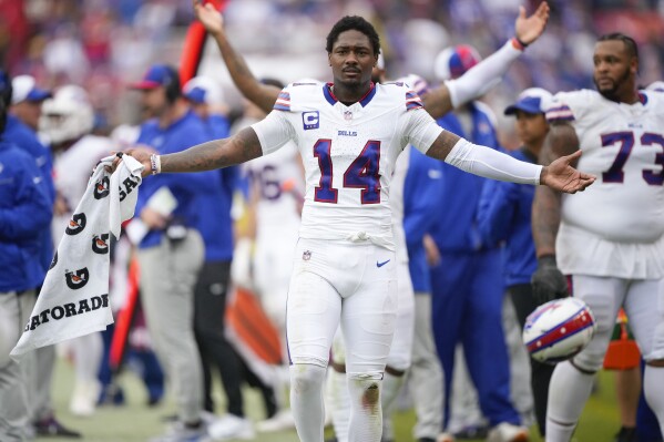Buffalo Bills wide receiver Stefon Diggs (14) celebrating on the sidelines after Bills scored a touchdown against the Washington Commanders during the second half of an NFL football game, Sunday, Sept. 24, 2023, in Landover, Md. (AP Photo/Andrew Harnik)