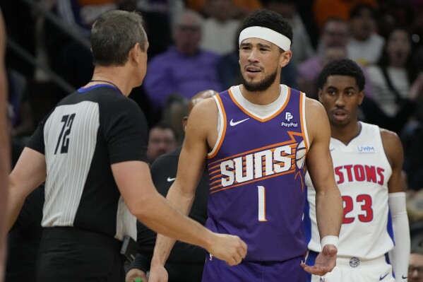 Phoenix Suns guard Devin Booker (1) reacts after getting ejected from the game by referee J.T. Orr (72) during the first half of an NBA basketball game against the Detroit Pistons, Wednesday, Feb. 14, 2024, in Phoenix. (APPhoto/Rick Scuteri)