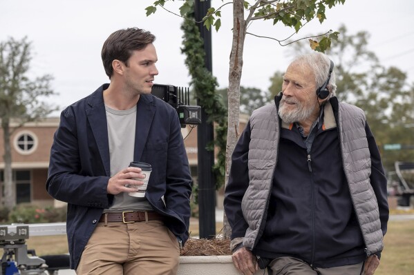 This image released by Warner Bros. Entertainment shows Nicholas Hoult, left, and director Clint Eastwood behind the scenes during production for "Juror #2". (Warner Bros. Entertainment via AP)