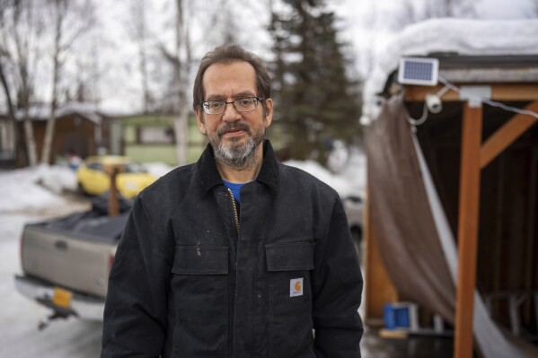 Timothy Hoffman stands outside his home on Tuesday, Nov. 28, 2023, in Anchorage, Alaska. Hoffman, the father of an Alaska woman killed in a murder-for-hire scheme in 2019, died, Sunday, June 2, 2024, during a weekend memorial motorcycle ride commemorating the fifth anniversary of her death. (Loren Holmes/Anchorage Daily News via AP)
