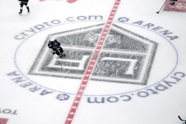 Members of the Los Angeles Kings warm up at crypto.com Arena prior to an NHL hockey game between the Kings and the Seattle Kraken Tuesday, Nov. 29, 2022, in Los Angeles. (AP Photo/Mark J. Terrill, File)