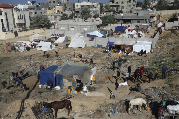 Palestinians displaced by Israeli bombing of the Gaza Strip set up tents in Deir al-Balah, Tuesday, Dec. 26, 2023.  (AP Photo/Adel Hana)