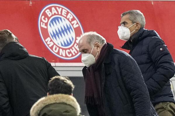 FILE - Former Bayer president Uli Hoeness leaves his place with a face mask at halftime of he German Bundesliga soccer match between Bayern Munich and Arminia Bielefeld at the Allianz Arena in Munich, Germany, Saturday, Nov. 27, 2021. German club’s preparations for the Bundesliga’s resumption after the winter break are being hampered by multiple coronavirus infections. (AP Photo/Martin Meissner, File)