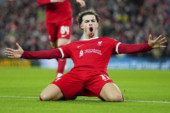 Liverpool's Curtis Jones celebrates scoring his side's 5th goal during the English League Cup quarterfinal soccer match between Liverpool and West Ham United at the Anfield stadium in Liverpool, England, Wednesday, Dec. 20, 2023. (AP Photo/Jon Super)