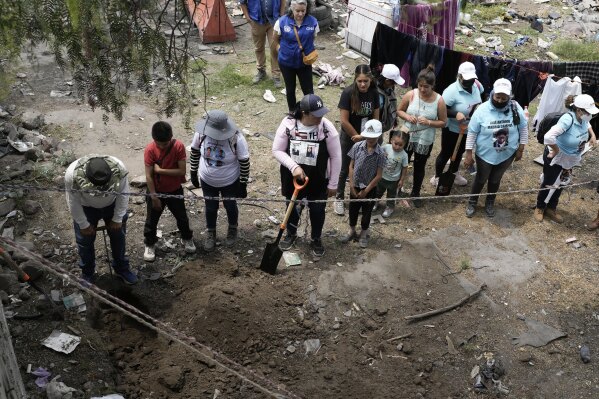 Relatives search for their missing loved ones in a clandestine grave in Zumpango, Mexico, Friday, April 19, 2024. Hundreds of collectives searching for missing loved ones fanned out across Mexico on Friday as part of a coordinated effort to raise the profile of efforts that are led by the families of the tens of thousands of missing across Mexico without support from the government. (AP Photo/Marco Ugarte)