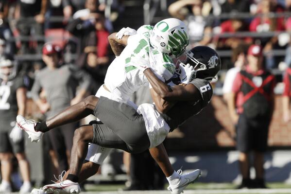Washington State defensive back Chau Smith-Wade (6) tackles Oregon wide receiver Troy Franklin (11) during the second half of an NCAA college football game, Saturday, Sept. 24, 2022, in Pullman, Wash. (AP Photo/Young Kwak)