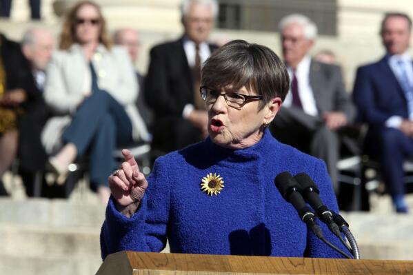 FILE - Kansas Gov. Laura Kelly gives her inaugural address to start her second term in office, Monday, Jan. 9, 2023, outside the Statehouse in Topeka, Kan. The Democratic governor has vetoed a Republican transgender bathroom bill and a GOP plan for ending gender-affirming care for trans youth. (AP Photo/John Hanna)