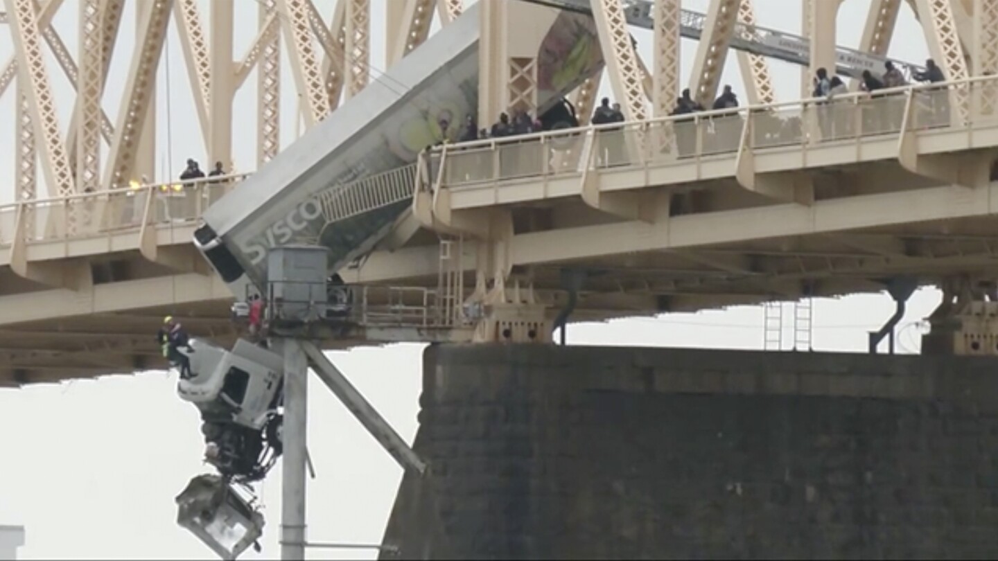 Rescue of truck driver dangling from bridge was a team effort