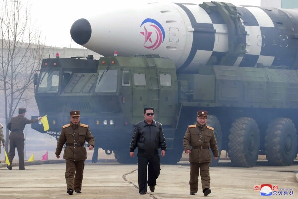 FILE - In this photo distributed by the North Korean government, North Korean leader Kim Jong Un, center, walks around what it says is a Hwasong-17 intercontinental ballistic missile (ICBM) on the launcher at an undisclosed location in North Korea on March 24, 2022. Independent journalists were not given access to cover the event depicted in this image distributed by the North Korean government. The content of this image is as provided and cannot be independently verified. Korean language watermark on image as provided by source reads: "KCNA" which is the abbreviation for Korean Central News Agency. (Korean Central News Agency/Korea News Service via AP, File)