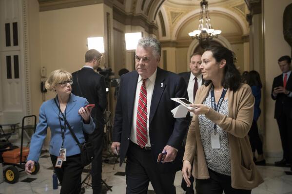 Rep. Peter King, R-N.Y., leaves the House chamber after the House gave a significant boost to President Donald Trump's promise to cut taxes, narrowly passing a GOP budget that shelves longstanding concern over federal deficits in favor of a rewrite of the tax code, on Capitol Hill in Washington, Thursday, Oct. 26, 2017. GOP leaders scrambled in recent days to overcame opposition by Republicans from high-tax states such as New York and New Jersey, like King, who represents Long Island, and who were upset about plans to curb the state and local tax deduction. (AP Photo/J. Scott Applewhite)