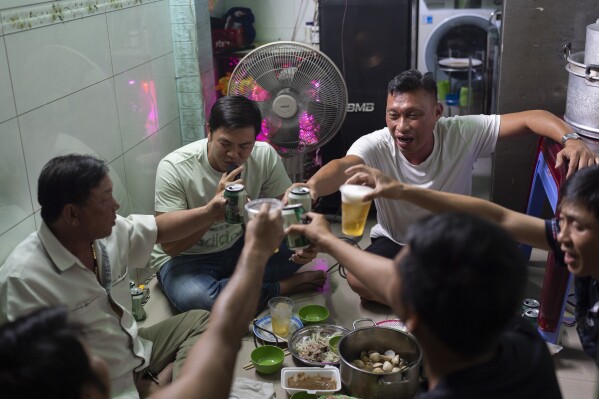 Local residents toast with beer as they gather for karaoke in Ho Chi Minh City, Vietnam, Jan. 11, 2024. (AP Photo/Jae C. Hong)