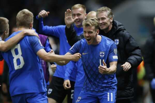 Finland's players celebrate after scoring their side's first goal scored by Oliver Antman, left, during the Euro 2024 group H qualifying soccer match between Kazakhstan and Finland at the Astana Arena in Astana, Kazakhstan, Thursday, Sept. 7, 2023. (AP Photo/Stas Filippov)