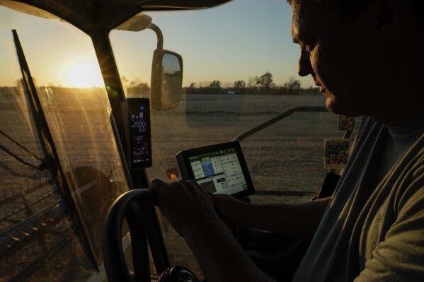 Jed Clark drives his combine while harvesting soybeans, Wednesday, Nov. 8, 2023, in Lynnville, Ky. After historic rainfall in July 2023, floods submerged crops on Clark's farm, destroying about 18 acres of tobacco crop and 200 acres of soybeans. (AP Photo/Joshua A. Bickel)