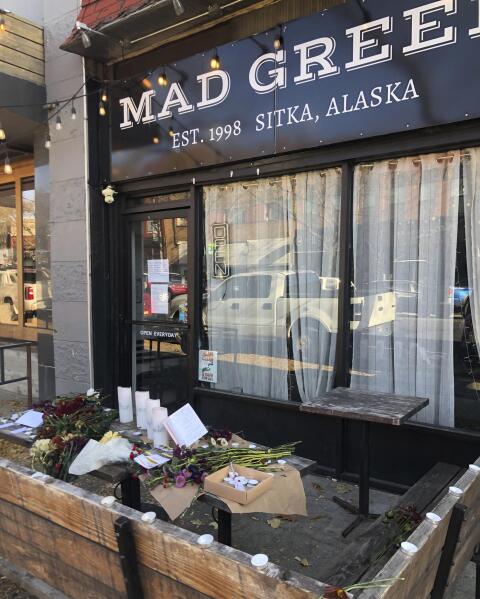 Candles and flowers are left at a make-shift memorial honoring four slain University of Idaho students outside the Mad Greek restaurant in downtown Moscow, Idaho, on Tuesday, Nov. 15, 2022. Police discovered the bodies of the four students at home near campus on Sunday, Nov. 13, 2022, and said the killer or killers used a knife or bladed weapon in the targeted attack. Two of the victims, 21-year-old Madison Mogen and 20-year-old Xana Kernodle, were servers at Mad Greek. (AP Photo/Nicholas K. Geranios)