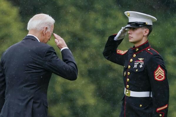 President Joe Biden returns a salute as he walks to board Marine One at Fort Lesley J. McNair in Washington, Monday, Aug. 16, 2021, en route to Camp David after addressing the nation from the White House about Afghanistan. (AP Photo/Manuel Balce Ceneta)