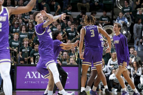 James Madison players react after upsetting Michigan State in an NCAA college basketball game, Monday, Nov. 6, 2023, in East Lansing, Mich. (AP Photo/Al Goldis)
