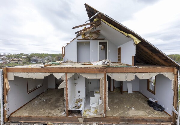 A partially torn off roof is seen on a damaged home in Omaha, Neb., on Saturday, April 27, 2024. Dozens of reported tornadoes wreaked havoc Friday in the Midwest. (Chris Machian/Omaha World-Herald via AP)