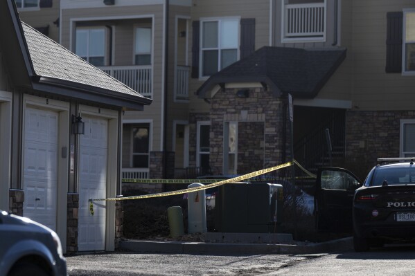 FILE - Police tape marks a crime scene where Colorado Springs police found children dead inside a condo of the Palomino Ranch Point complex after responding to a 911 call reporting a burglary, Tuesday, Dec. 19, 2023, in Colorado Springs, Colo. The Colorado mother suspected of killing two of her young children and wounding a third was arrested Saturday, Dec. 30, in the United Kingdom, authorities said. (Parker Seibold/The Gazette via AP, File)