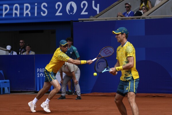 Matthew Ebden and John Peers of Australia play against Austin Krajicek and Rajeev Ram of the United States during their men's doubles gold medal match at the Roland Garros stadium, at the 2024 Summer Olympics, Saturday, Aug. 3, 2024, in Paris, France. (AP Photo/Andy Wong)