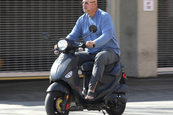 Cleveland Indians manager Terry Francona leaves Progressive Field in Cleveland on his scooter on the scheduled day of the Indians' home opening baseball game on March 26, 2020. Slowed by major health issues in recent years, the personable, popular Francona may be stepping away, but not before leaving a lasting imprint as a manager and as one of the game's most beloved figures. (John Kuntz/Cleveland.com via AP)