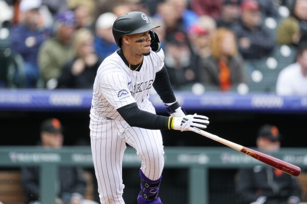 Colorado Rockies' Ezequiel Tovar heads up the first-base line with a single against San Francisco Giants starting pitcher Keaton Winn in the first inning of a baseball game Thursday, May 9, 2024, in Denver. (AP Photo/David Zalubowski)