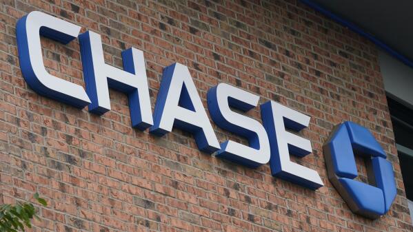 A Chase bank sign is shown in Richmond, Va., Wednesday, June 2, 2021.  JPMorgan Chase’s said, Friday, Jan. 14, 2022 its fourth quarter profits fell 14% from a year earlier, as the company saw a weaker performance out of its trading desk and had higher compensation expenses for its employees. (AP Photo/Steve Helber)