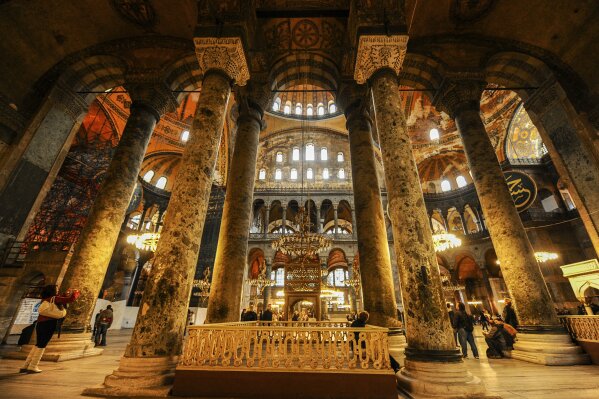 Visitors walk inside the Byzantine-era Hagia Sophia, in the historic Sultanahmet district of Istanbul, Friday, Oct. 15, 2010. Turkish President Recep Tayyip Erdogan is scheduled to join hundreds of worshipers Friday, July 24, 2020, for the first Muslim prayers at the Hagia Sophia in 86 years, weeks after a controversial high court ruling paved the way for the landmark monument to be turned back into a mosque. The conversion of the edifice, once the most important church of Christendom and the "jewel" of the Byzantine Empire, has led to an international outcry. (AP Photo/Emrah Gurel)