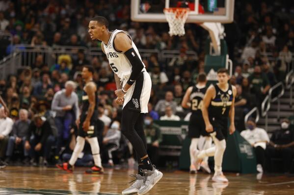 San Antonio Spurs guard Dejounte Murray (5) reacts to making shot against the Milwaukee Bucks during the second half of an NBA basketball game Saturday, Oct. 30, 2021, in Milwaukee. (AP Photo/Jeffrey Phelps)