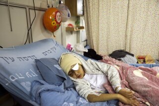 FILE - In this Feb. 20, 2020 file photo, 9-year-old Palestinian boy Malik Eissa rests in Hadassa hospital in Jerusalem. Israeli authorities have cleared police of any wrongdoing in the case of Eissa who lost an eye after apparently being shot in the face by an Israeli officer with what appeared to be a sponge-tipped munition last February. In a statement sent to The Associated Press on Saturday, Dec. 5, 2020, the Israeli Justice Ministry said its unit for internal police investigations concluded that while the incident was “sad,” there were insufficient grounds for prosecution after interviewing witnesses and reviewing video footage and other evidence. (AP Photo/Mahmoud Illean, File)