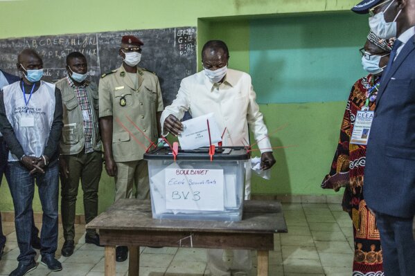 Guinean President Alpha Conde casts his ballot in Conakry, Guinea, Sunday Oct. 18, 2020. Guinean President Alpha Conde is seeking to extend his decade in power, facing off against his longtime rival Cellou Dalein Diallo for the third time at the polls. (AP Photo/Sadak Souici)