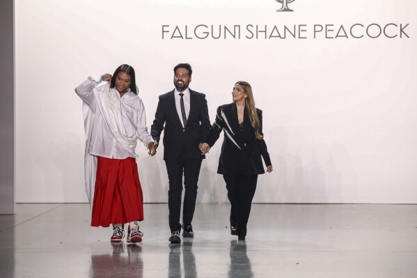 Fashion designers Law Roach, from left, Shane Peacock and Falguni Peacock attend the Falguni Shane Peacock Spring/Summer 2024 fashion show as part of New York Fashion Week on Monday, Sept. 11, 2023, in New York. (Photo by Andy Kropa/Invision/AP)