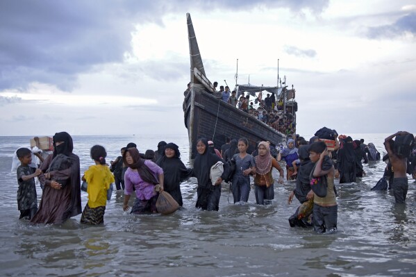 FILE - Ethnic Rohingya disembark from their boat upon landing in Ulee Madon, North Aceh, Indonesia, Thursday, Nov. 16, 2023. Indonesian authorities detected at least five boats packed tight with refugees approaching shores of Aceh province, the latest in a surge of vessels that have arrived in Aceh, most carrying Rohingya refugees from southern Bangladesh, where the persecuted Muslim minority fled in 2017 following attacks by the military in their homeland of Myanmar. (AP Photo/Rahmat Mirza, File)