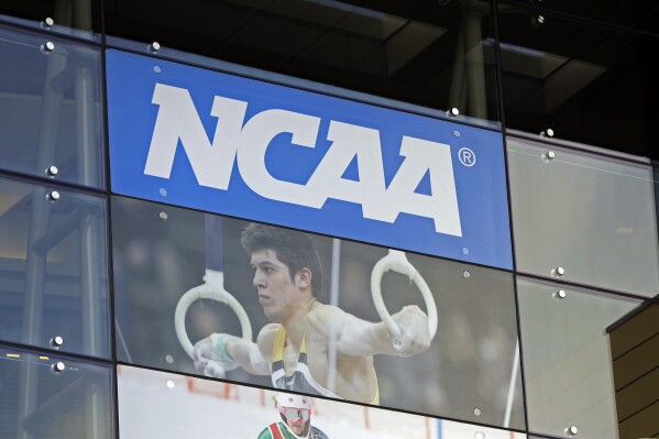 FILE - NCAA headquarters is shown in Indianapolis, April 25, 2018. A member of the NCAA’s Committee on Infractions has resigned over NCAA policies regarding participation of transgender athletes. William Bock is also a former general counsel of the U.S. Anti-Doping Agency. He says NCAA policies permitting transgender athletes to compete against women are unfair. (AP Photo/Darron Cummings, File)