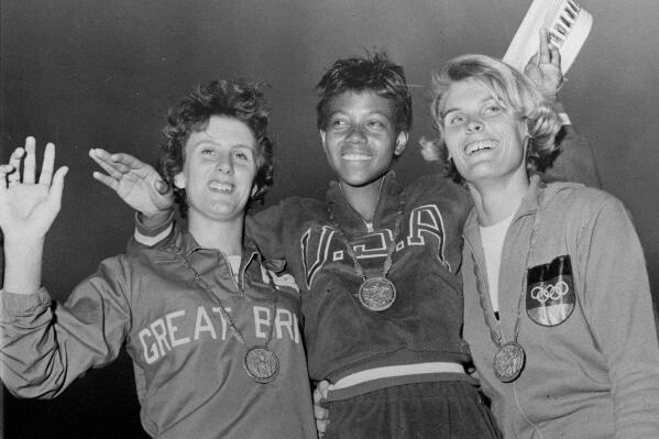 FILE - In this Sept. 5, 1960, file photo, the medalists in the women's 200-meter event, from left, bronze medalist Dorothy Hyman, of Great Britain; gold medalist Wilma Rudolph, of the United States, and silver medalist Jutta Heine, of Germany, pose with their medals at the Olympic stadium in Rome, Italy. It has been 50 years since Title IX was signed into law by President Nixon. The measure barred discrimination against women when it came to programs that receive federal assistance. (AP Photo/File)