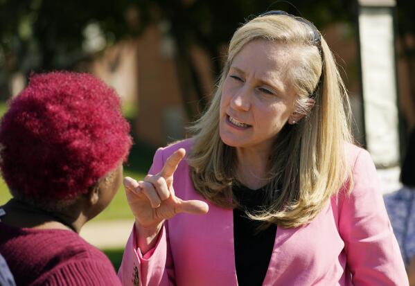 FILE - U.S. Rep Abigail Spanberger, D-Va., right, talks with a supporter at an early voting location, Tuesday, Oct. 11, 2022, in Stafford, Va.  The race for Virginia's 7th Congressional District is a nail-biter in the final stretch and a contest that could help determine which party controls the U.S. House. (AP Photo/Steve Helber, File)