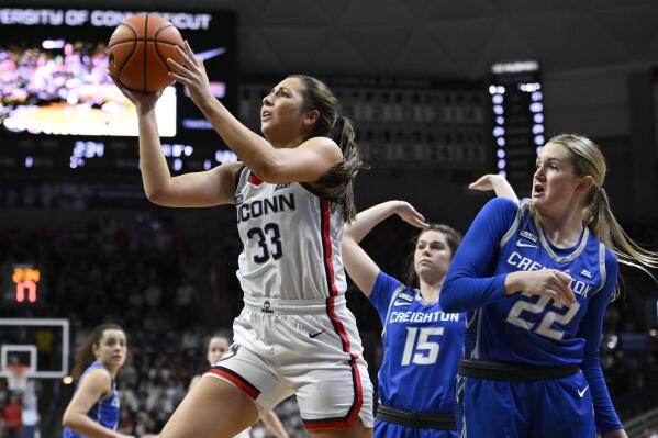 UConn's Caroline Ducharme (33) shoots as Creighton's Lauren Jensen (15) and Carly Bachelor (22) defend during the second half of an NCAA college basketball game Wednesday, Feb. 15, 2023, in Storrs, Conn. (AP Photo/Jessica Hill)