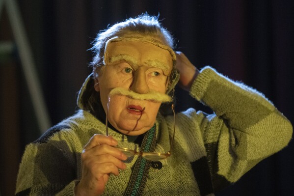 An actress prepares to take the stage of the Chernihiv Regional Youth Theater, which reinvented itself with an all-female cast, with most male actors at war, in Chernihiv, Ukraine, Sunday, Feb. 16, 2025. (AP Photo/Efrem Lukatsky)