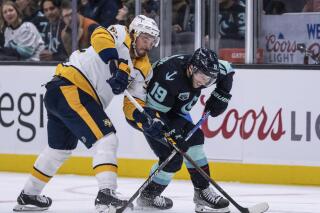 Seattle Kraken forward Calle Jarnkrok, right, and Nashville Predators forward Matt Duchene vie for the puck during the second period of an NHL hockey game Wednesday, March 2, 2022, in Seattle. (AP Photo/Stephen Brashear)