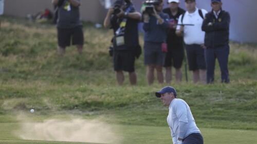 Northern Ireland's Rory McIlroy plays out of a bunker on the 18th green on the first day of the British Open Golf Championships at the Royal Liverpool Golf Club in Hoylake, England, Thursday, July 20, 2023. (AP Photo/Peter Morrison)