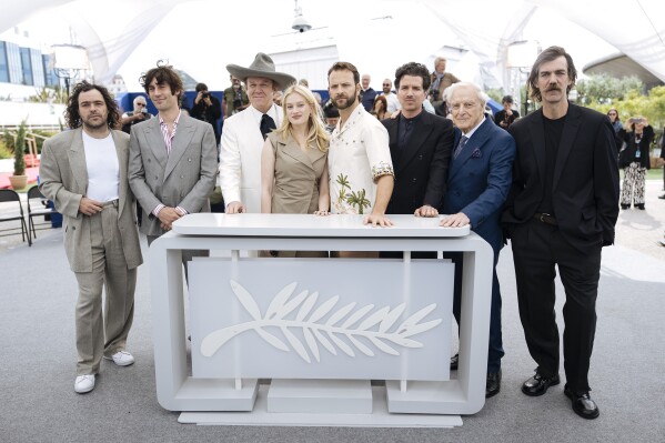 Peter Lanzani from left, director Matteo Zoppis, John C. Reilly, Nadia Tereszkiewicz, Alessandro Borghi, director Alessio Rigo de Righi, Gianni Garko and Gabriele Silli Pose for photographers in the photo 
