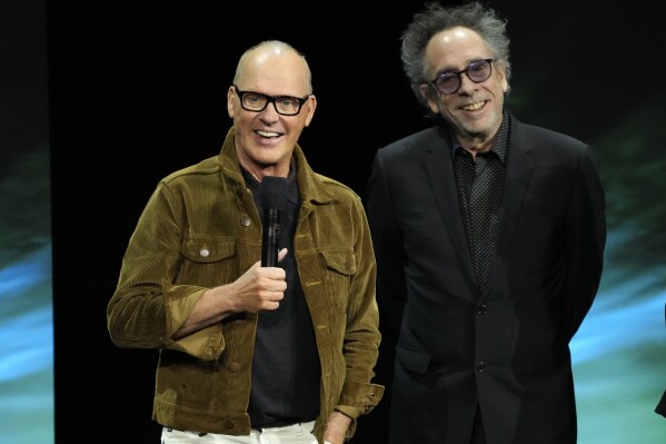 Michael Keaton, left, star of the upcoming film "Beetlejuice Beetlejuice," discusses the film alongside director Tim Burton during the Warner Bros. Pictures presentation at CinemaCon 2024, Tuesday, April 9, 2024, in Las Vegas. (AP Photo/Chris Pizzello)